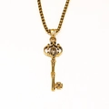 Detailed macro view of vintage gothic crown key pendant with box chain in gold finish - Gold Color Pendant