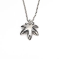 Macro shot of maple leaf pendant in polished stainless steel on a woven metal chain - Pendant Only (Without Chain) (Steel Color)