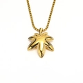 Macro shot of gold maple leaf pendant with polished metallic finish on a box chain - Pendant Only (Without Chain) (Gold)