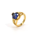 Macro detail of gold-plated ring featuring a large faceted blue gemstone and hollow band - Gold Plated Blue Zirconia