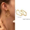 Boucles d'oreilles dorées irrégulières en acier titane portées avec dimensions - Vague Épurée Creuse (ZJGE0544)