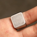 Macro shot of matte silver compass engraving on a square vintage steel ring for men - US 7 / Steel