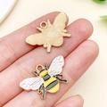 Enamel honey bee charm for DIY jewelry making shown in hand for size reference - KC Gold Enamel Bee (11996) / 26x17mm