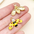 Bee shaped jewelry pendant with heart wings, pearl head, and golden finish in hand - KC Gold Yellow Pearl Heart Bee (23785) / 17x23x7mm