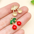 Enameled cherry pendant in red and gold finish for DIY jewelry and keychain making - Red Cherry Charm (23439)