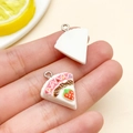 DIY cake slice resin charms with metal rings shown in hand for size visualization - Triangular Strawberry Cake
