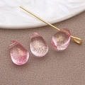 Pink teardrop glass bead for jewelry making with gold foil details on fabric backdrop - Teardrop Pendant (23671) / 1 Piece (9x6x5mm) / Small Transparent Pink