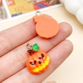Cute resin pumpkin pendant in orange with black face detail and silver metal ring loop - Orange Pumpkin (24203) / 16x22mm