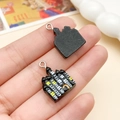 DIY Halloween resin charm featuring a black spooky castle silhouette with yellow windows - Castle House (24223) / 16x21mm