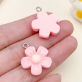 Pink resin cherry blossom flower pendant with metal ring shown on palm for size reference - Pink Resin Five-Petal Cherry Blossom (24330) / 22x19x6mm