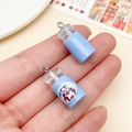 Pair of mini light blue resin milk bottle charms with cartoon cow label for DIY - Transparent Blue Milk Bottle