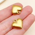 Minimalist solid gold-plated heart charms for DIY jewelry making shown on finger for scale - 16x17x5mm Gold Stainless Steel Small Heart (T2355)