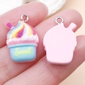 Rainbow resin cupcake charm with Sweet text for DIY necklace making shown in hand - Pink Base Lake Blue Style (24526)