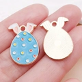 Blue Easter bunny egg charm with colorful polka dots and a golden textured back - Lake Blue Enamel Spotted Bunny Egg