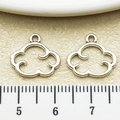 Detail view of cloud-shaped silver pendants with sizing ruler for DIY jewelry making - Antique Silver Hollow Cloud Border (15489)