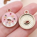 Pink and gold donut enamel charms for DIY jewelry making shown on hand palm - Pink Enamel Round Donut (15659)