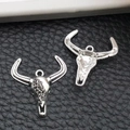 Detailed close-up of vintage silver bull skull pendants with floral scroll engravings - Scroll Pattern Bull Head (16967) / 18x20mm