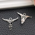 Detailed close-up of antique silver bull skull charms with sunburst engraving on leather - Sun Pattern Bull Head (16968) / 22x17mm