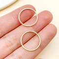 Minimalist vacuum plated gold stainless steel thin band rings shown on fingertips - Round Shape (T1870) / Gold