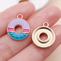 Handheld view of a colorful three-color donut charm in rose gold finish for DIY crafts - Purple Blue Enamel Donut (24692)