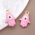 Colgante Mano de Fátima rosa con ojo turco y acabado dorado para joyería DIY - Ojo Turco Hamsa Rosa / 9x13mm