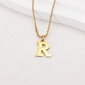 Macro detail of golden letter R pendant on a box chain over white textured background - Letter R (BJGN0271) / Gold