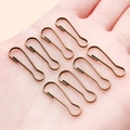 7 antique bronze iron safety pins for DIY jewelry making shown on a palm for scale - 7x22mm / Antique Bronze