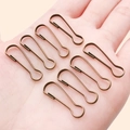 Bronze pear-shaped safety pins and DIY metal clasps shown on a hand for scale - 8.5x27mm / Antique Bronze