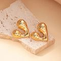 Detailed view of 18K gold plated heart earrings with hammered texture on stone surface - Gold Irregular Hammered Geometric Style (#0338)