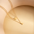 Double-layered gold necklace featuring a heart charm and letter L pendant - Letter L