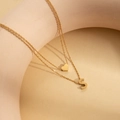Double-layered golden stainless steel necklace with heart and letter S pendant charms - Letter S
