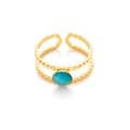 Detalle de anillo de doble capa dorado con piedra de ojo de gato azul y relieve de cuentas - Azul claro