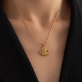 Close-up of a delicate gold titanium necklace with an octopus pendant on a neck - Octopus Necklace