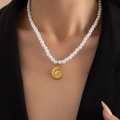 Macro detail of nautical gold nautilus pendant on elegant white pearl necklace worn by model - Artificial Pearl Conch (BJGN0393)