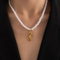 Close-up of a model wearing a gold seahorse pendant on a white pearl necklace strand - Artificial Pearl Seahorse (BJGN0395)