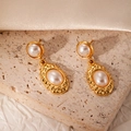 Close-up of pearl drop earrings with hammered gold texture on travertine stone surface - Artificial Pearl Earrings (BJGE1039)