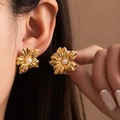 Close-up of artistic gold floral earrings featuring a lustrous white pearl center - Mirror Finish Six-petal Flower Pearl Stud (#1294)
