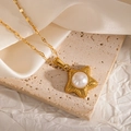 Close-up of gold star pendant with pearl on a textured chain over silk background - Five-pointed Star Shape (JJN0079)