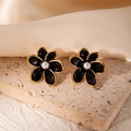 Close-up of vintage flower stud earrings with black enamel petals and white pearl centers - Black Flower (#0992)