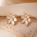 Floral stainless steel earrings with white enamel petals and pearl center on stone background - White Flower (#0991)