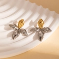 Detailed close-up of contrasting gold and silver metallic flower petal earrings on white board - Steel Color Four-leaf Earrings (BJGE1189)