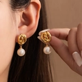 Elegant gold knotted pearl earrings featuring a twisted metal design on a female model - Knot Pearl Drop (#1008)