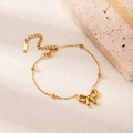 Minimalist gold stainless steel bracelet with bow pendant and delicate bead chain links - Bracelet