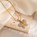 Detail of two-tone gold and silver butterfly pendant on a gold snake chain necklace - Double Layer Butterfly (JJN0170)