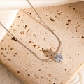 Detailed macro view of a silver necklace featuring a sparkling round claw-set diamond charm - Silver Single Zirconia Style (JJN0225)