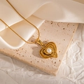 Macro detail of 18k gold heart necklace featuring a pearl inlay and a sleek snake chain - 3D Irregular Heart Shape (JJN0080)