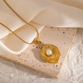 Detail of 18k gold plated necklace with sunburst textured pendant and central pearl inlay - Irregular Oval Layered Style (JJN0084)