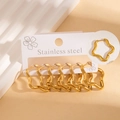 Set of six pairs of gold stainless steel wavy star earrings on a white display card - Wave Star Hoop Set (#1261)