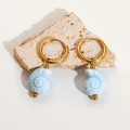 Detail of light blue ceramic conch earrings with gold metal hoops on stone - Light Blue Conch