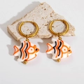 Detailed macro view of tropical fish earrings with orange stripes on natural stone - Orange Small Fish